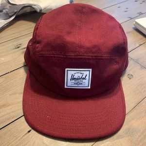 Maroon coloured 5 panel Herschel hat.